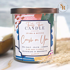 Fill your home with our sensual, mood-setting Crush On You scented soy wax candle.  A perfect blend of both airy and sophisticated as well as dark and mysterious. With seduction in the air, the sweet yet salty oceanic accords combine with an undercurrent of citrus, plum, amber, and dark musk. Crush On You is infused with natural essential oils, including cardamom seed and clove leaf. @SparkandRevive