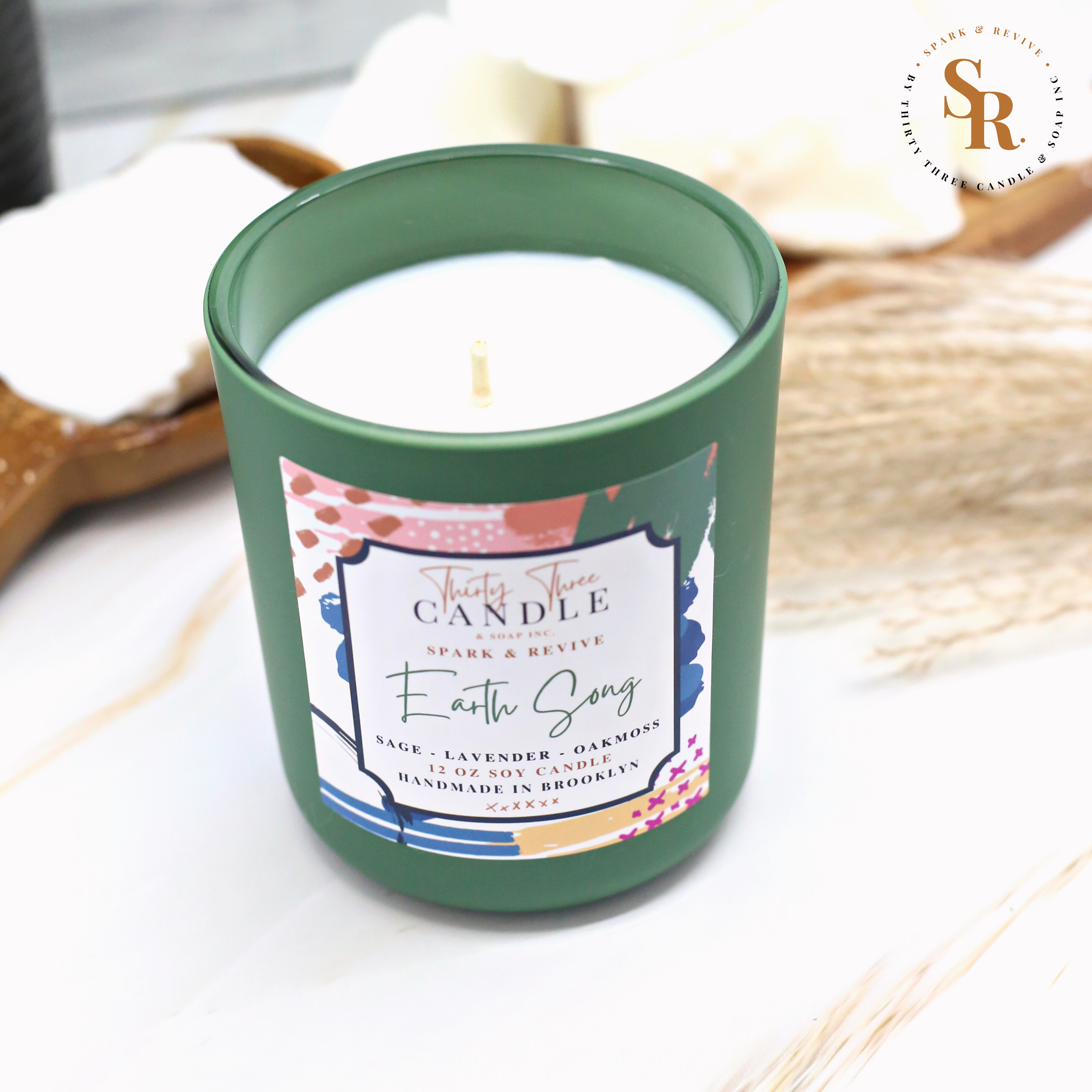 Looking to ground yourself and create an atmosphere soaked in intrigue?  Earth Song is a clean, sophisticated scented soy candle with universal appeal. This captivating fragrance sends you on an earth daydream with hints of orange, grapefruit, and an infusion of sage. Lavender, oakmoss, amber, and tonka round out the middle and base to bring a beautifully refined and irresistible essence to your space.  Earth Song is infused with natural essential oils, including sage, lavandin, and orange. @SparkandRevive