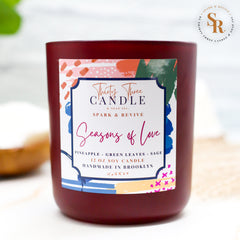 Uplift your mood and awaken your senses with our Seasons of Love scented soy candle. Seasons of Love is a sweet but not overwhelming blend of pineapple, sage, and green leaves. It is sure to put you in good spirits and bring love to your day. Seasons of Love is infused with natural essential oils, including eucalyptus, cedar, vetiver, palmarosa, clary sage, lemongrass, amyris, black pepper, cade, and blue chamomile flower. @SparkandRevive