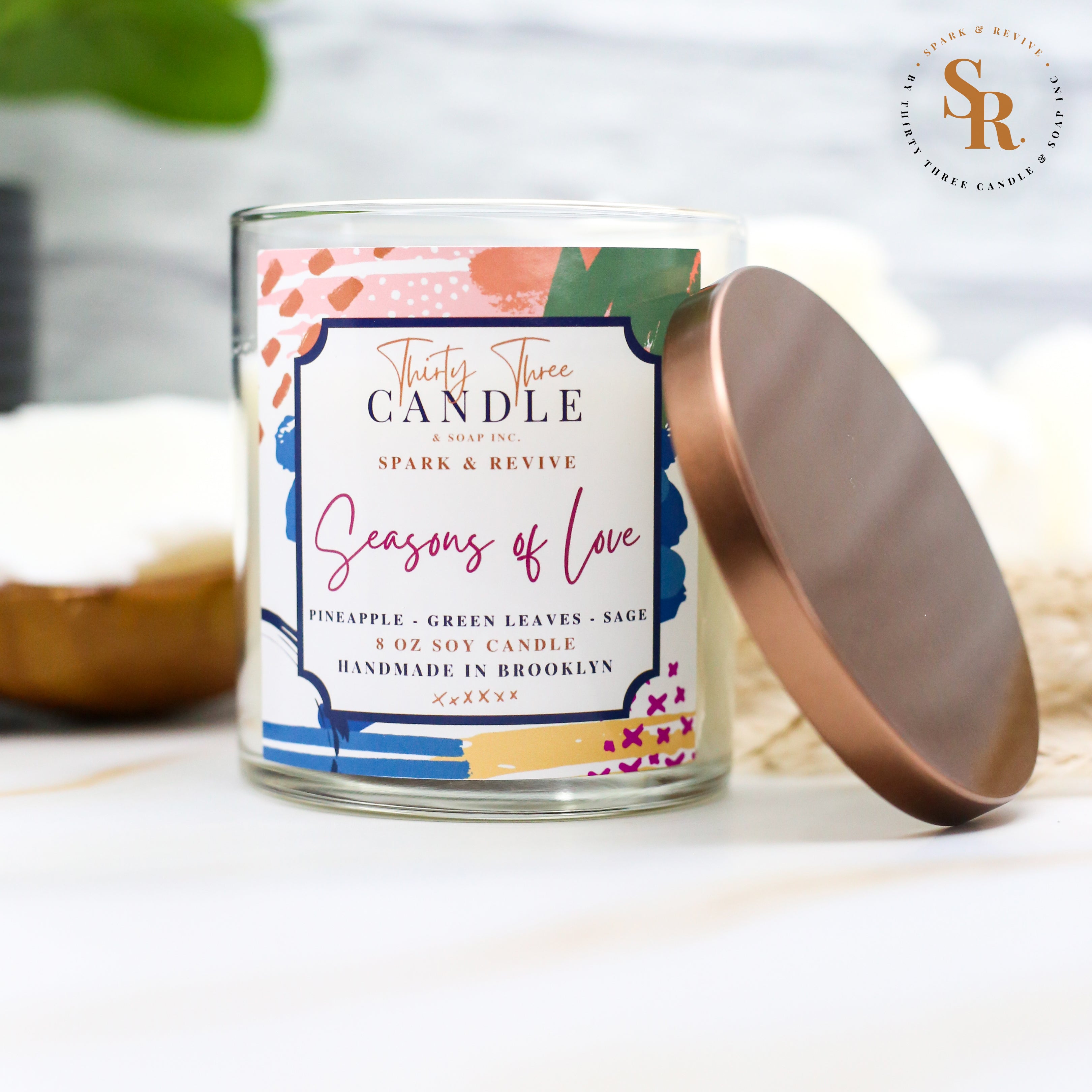 Uplift your mood and awaken your senses with our Seasons of Love scented soy candle. Seasons of Love is a sweet but not overwhelming blend of pineapple, sage, and green leaves. It is sure to put you in good spirits and bring love to your day. Seasons of Love is infused with natural essential oils, including eucalyptus, cedar, vetiver, palmarosa, clary sage, lemongrass, amyris, black pepper, cade, and blue chamomile flower. @SparkandRevive